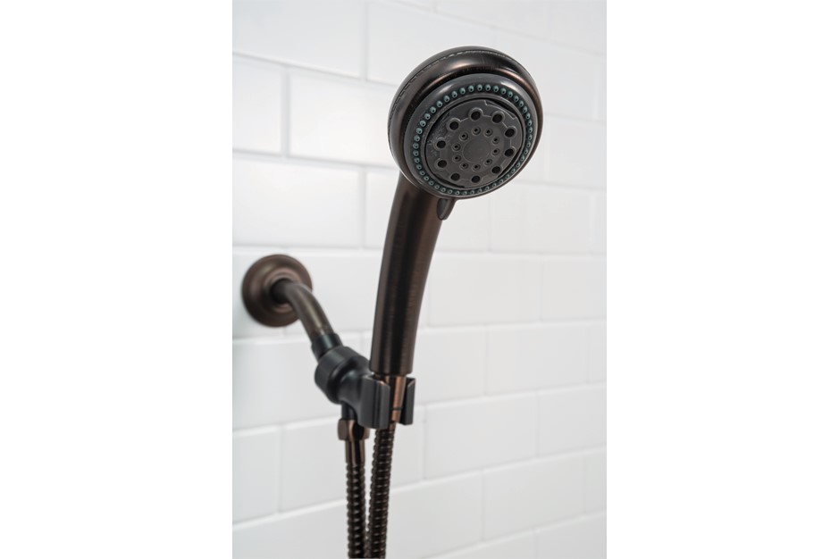 Bronze showerhead with multiple spray settings, mounted on a wall with white tiled background.