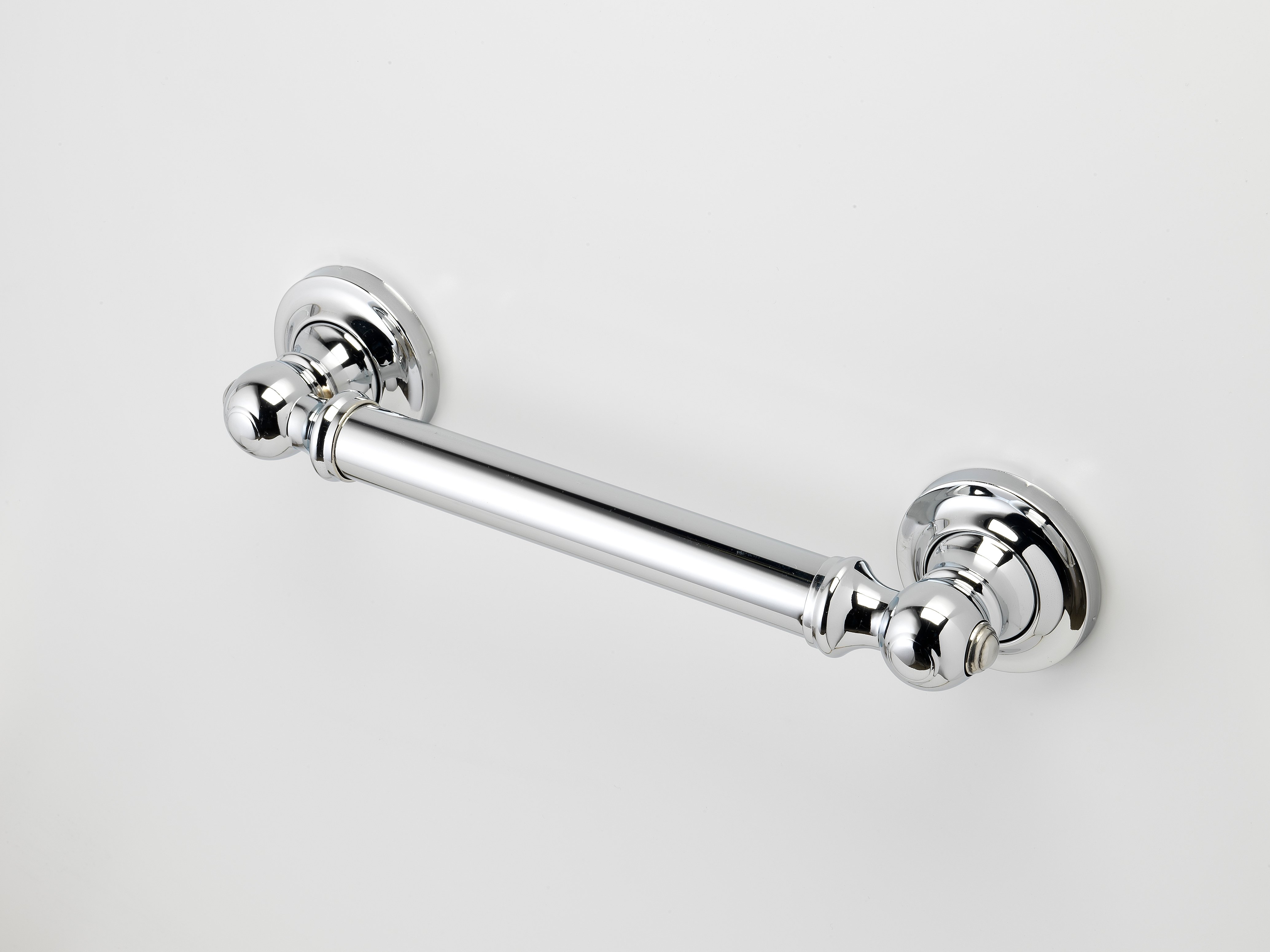 Chrome-plated grab bar mounted horizontally on a white wall.