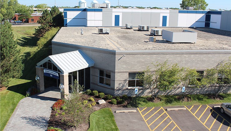 Exterior view of a gray brick building with a 