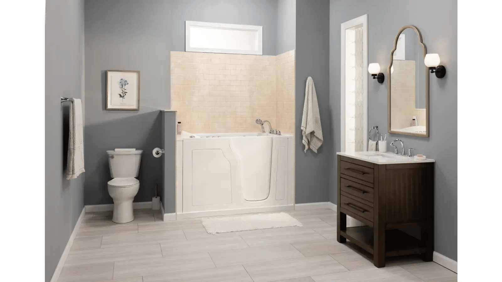 Bathroom with light gray walls and light wood-look floor tiles featuring a walk-in bathtub, toilet, and vanity.