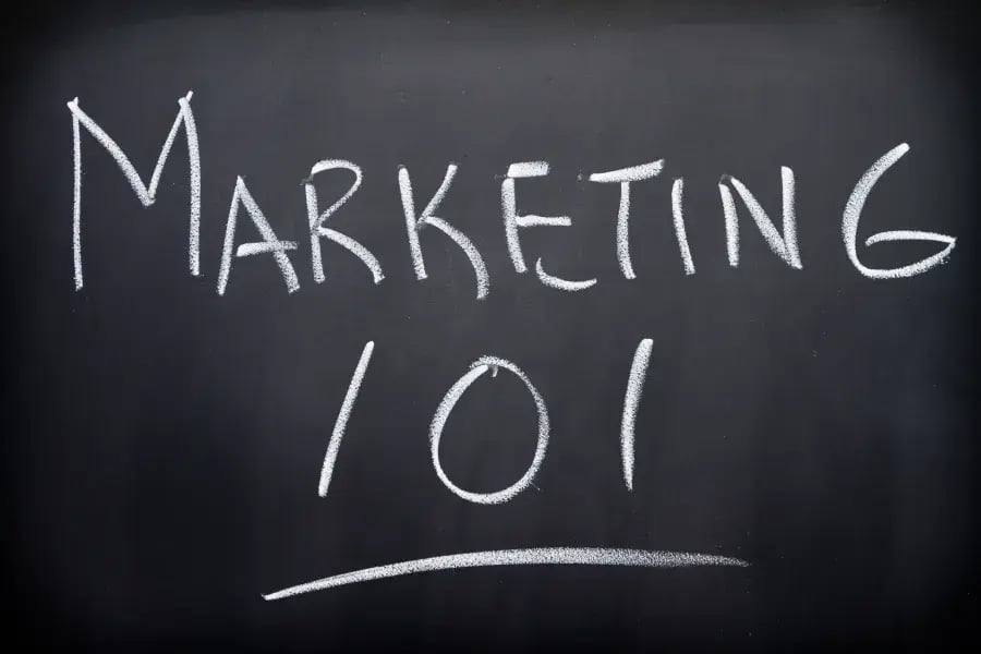 Marketing 101 in white chalk on a blackboard
