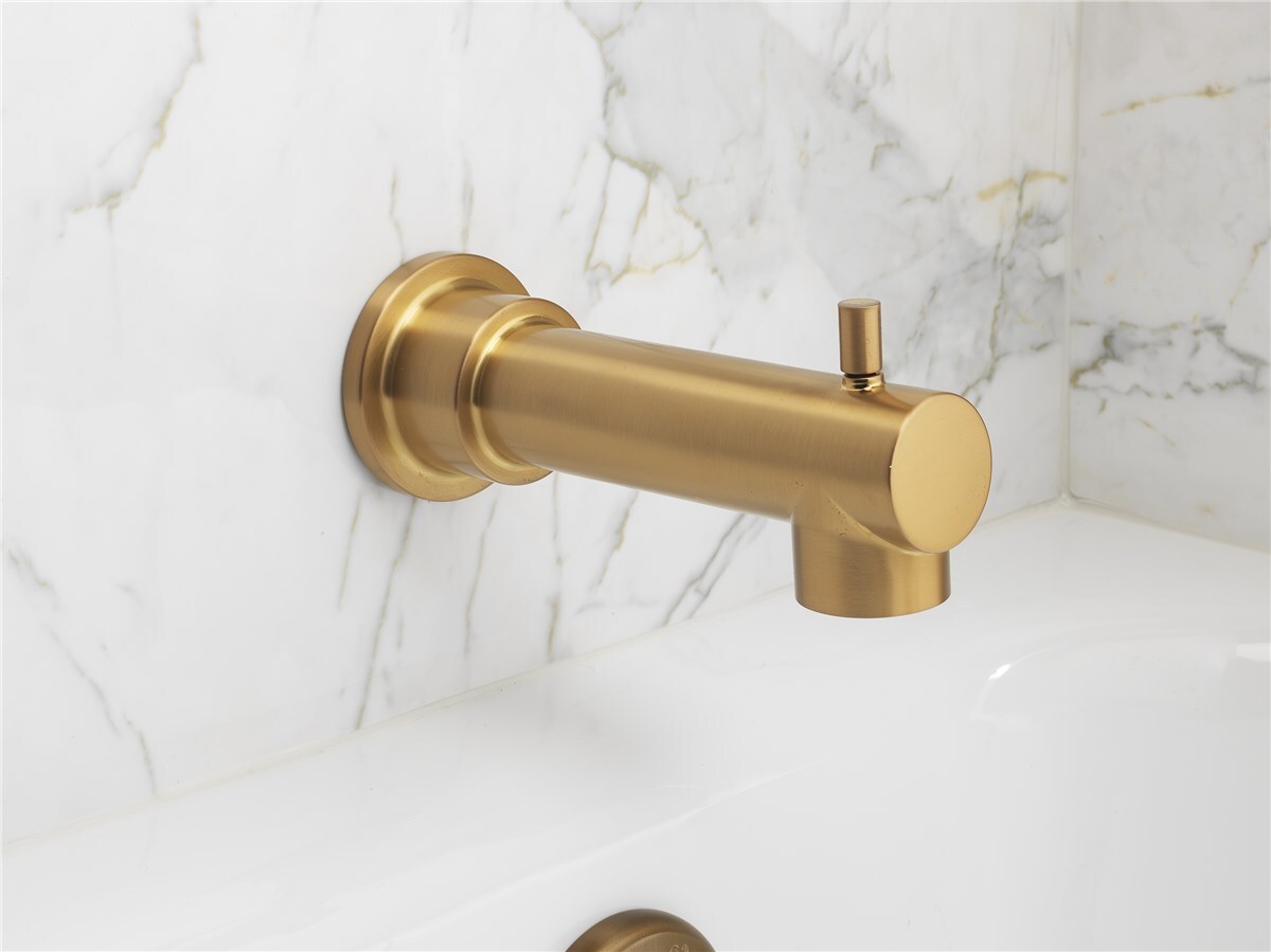 A sleek gold bathtub faucet attached to a white marble wall, featuring a simple lever for water control.