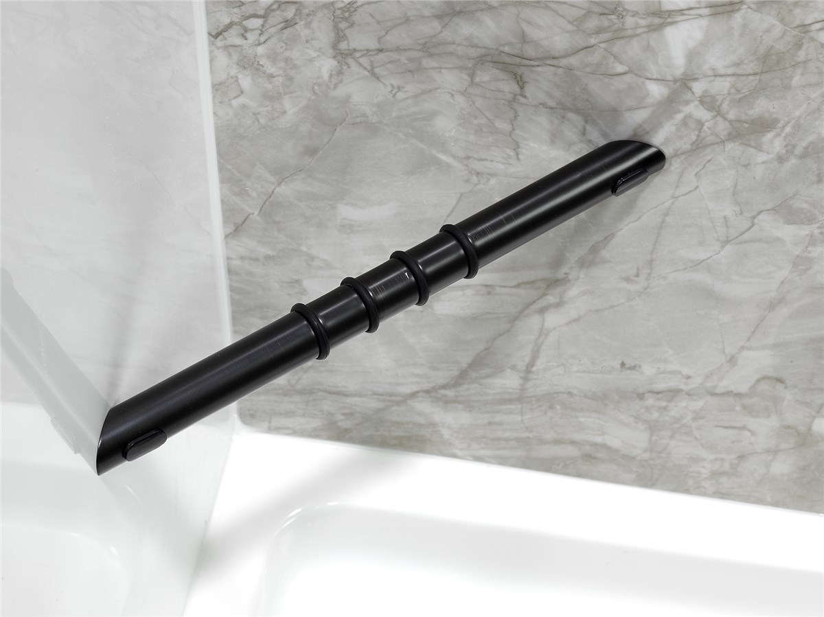A black grab bar is mounted diagonally on a gray marble-patterned shower wall above a white bathtub.