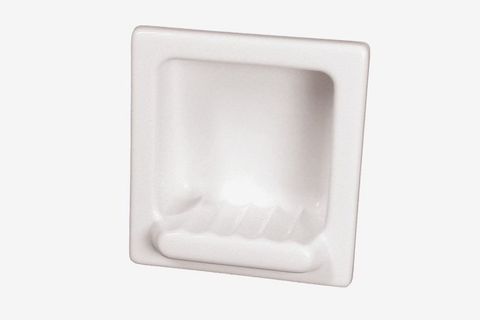 A white recessed ceramic soap dish with grooves, designed to be mounted flush into a wall, shown against a plain white background.